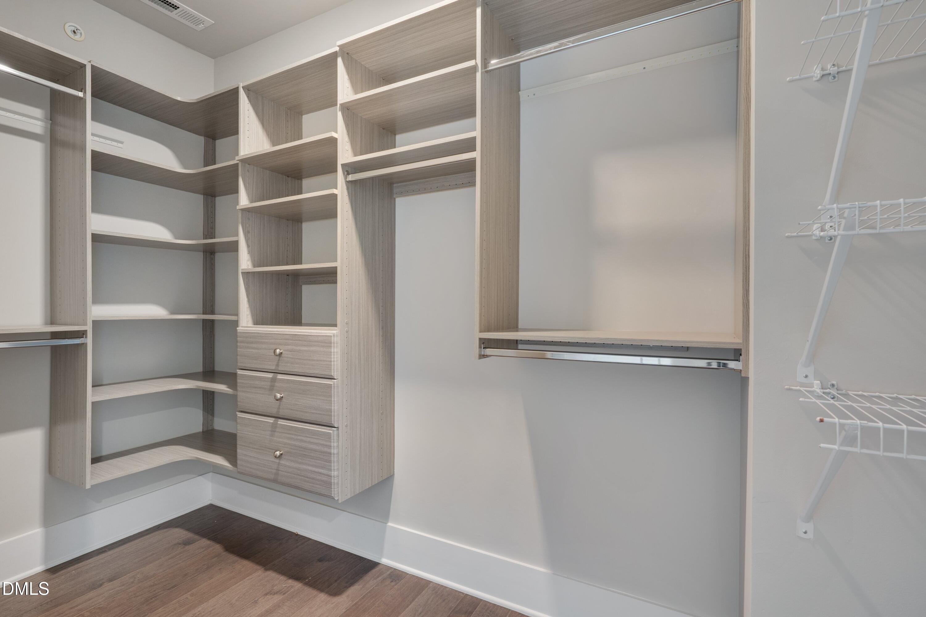 10330 Sablewood Drive, Unit 104 Raleigh, NC 27617 - Photo 14 of 39 a view of walk in closet with empty racks