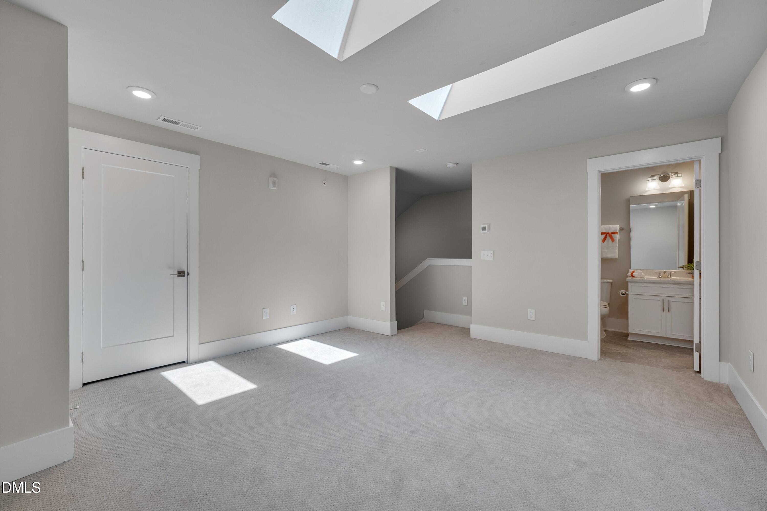 10330 Sablewood Drive, Unit 104 Raleigh, NC 27617 - Photo 20 of 39 an empty room with windows and bathroom view