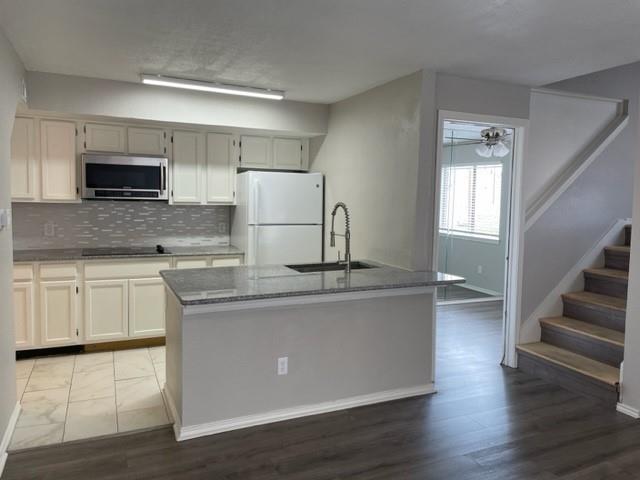 9831 West Walnut Street, Unit 206 Dallas, TX 75243 - Photo 1 of 21 a kitchen with stainless steel appliances a sink and microwave