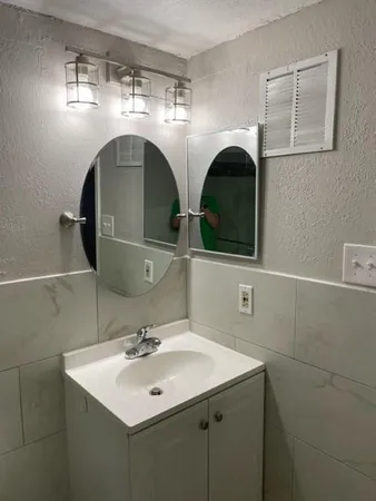 a white toilet sitting next to a bath tub and a shower