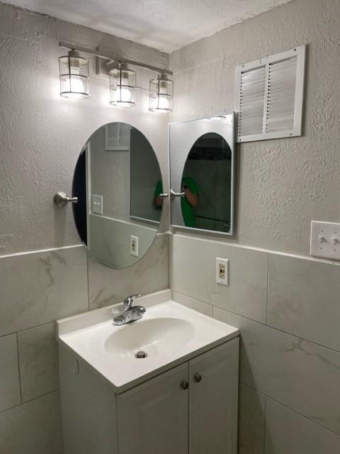 9831 West Walnut Street, Unit 206 Dallas, TX 75243 - Photo 13 of 21 a bathroom with double sink and two mirror