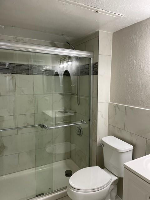 9831 West Walnut Street, Unit 206 Dallas, TX 75243 - Photo 14 of 21 a white toilet sitting next to a bath tub and a shower
