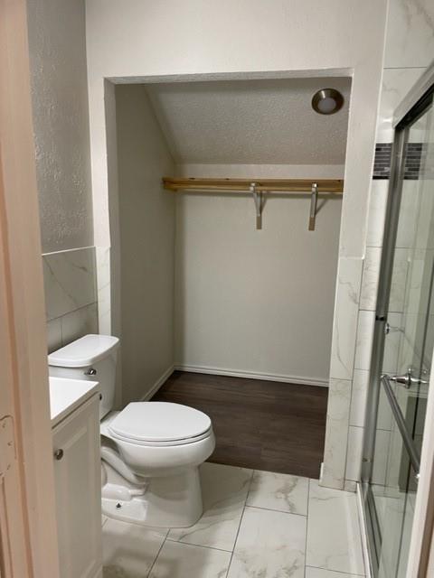 9831 West Walnut Street, Unit 206 Dallas, TX 75243 - Photo 20 of 21 a bathroom with a toilet and a shower