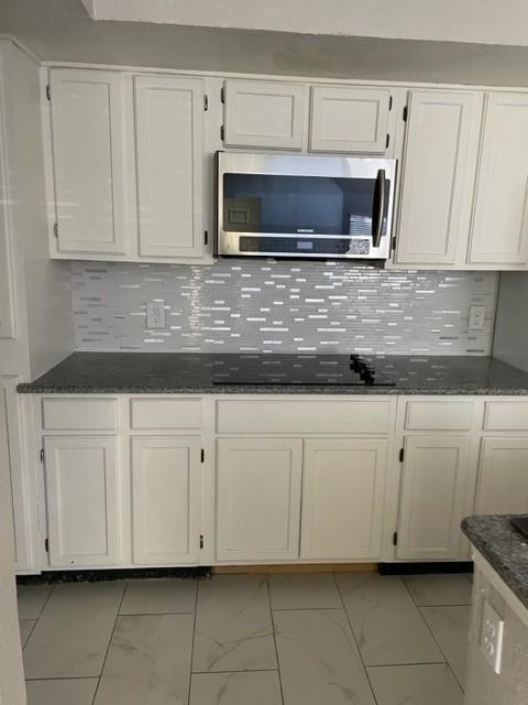 9831 West Walnut Street, Unit 206 Dallas, TX 75243 - Photo 2 of 21 a kitchen with white cabinets and a stove