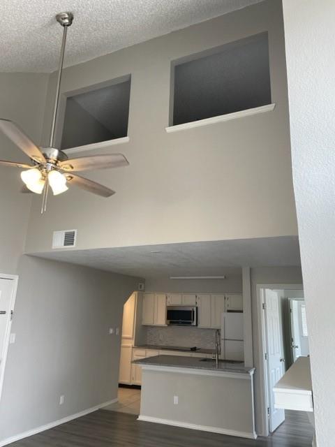 9831 West Walnut Street, Unit 206 Dallas, TX 75243 - Photo 9 of 21 a kitchen with a stove and a microwave