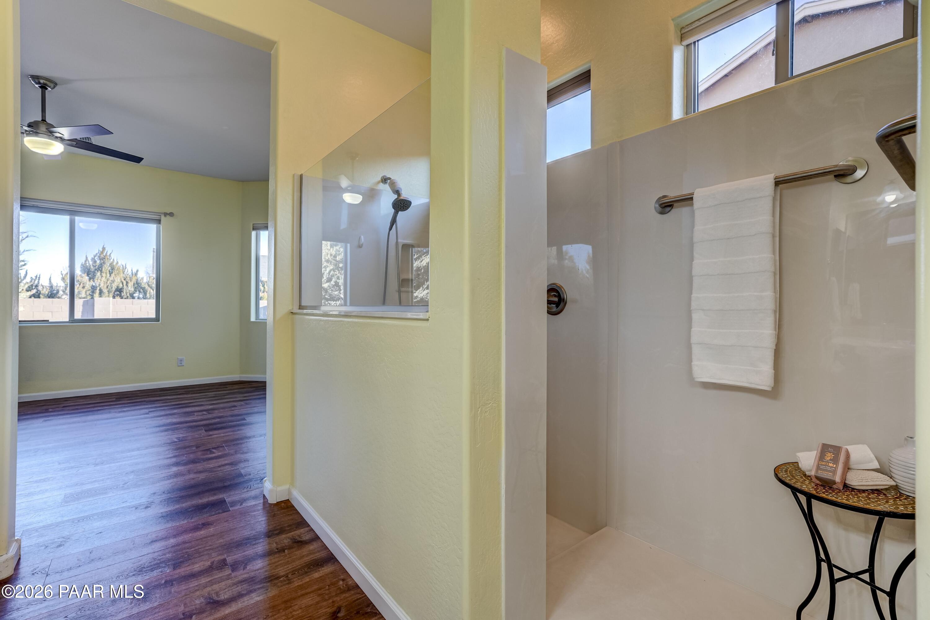7106 East Prairie Ridge Road Prescott Valley, AZ 86315 - Photo 15 of 27 a view of a hallway with wooden floor and a bathroom