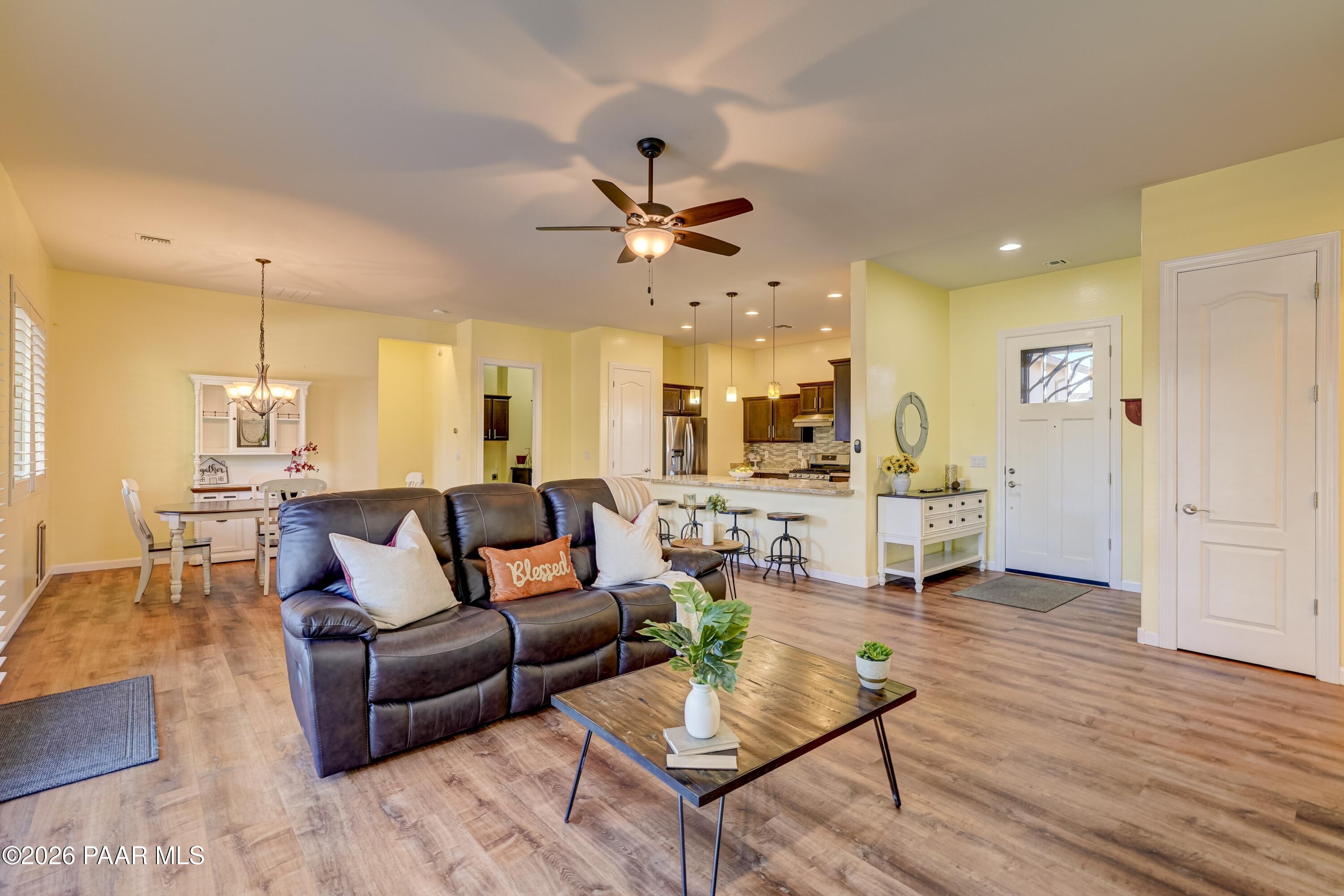 7106 East Prairie Ridge Road Prescott Valley, AZ 86315 - Photo 3 of 27 a living room with furniture kitchen view and a wooden floor