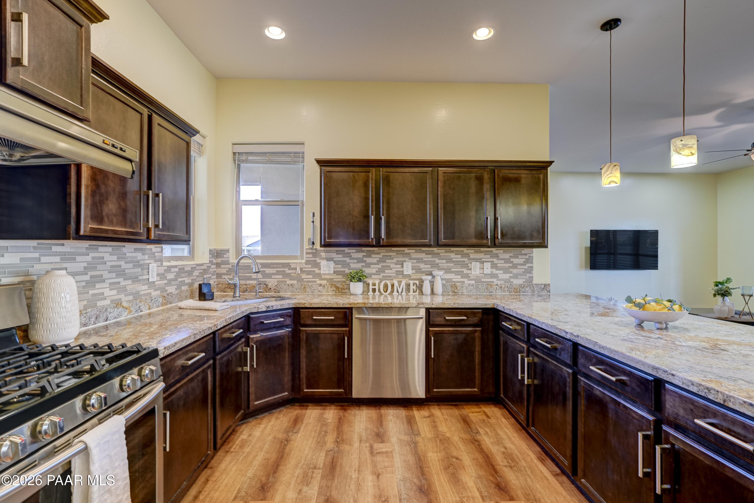 7106 East Prairie Ridge Road Prescott Valley, AZ 86315 - Photo 8 of 27 a kitchen with a sink stove and microwave