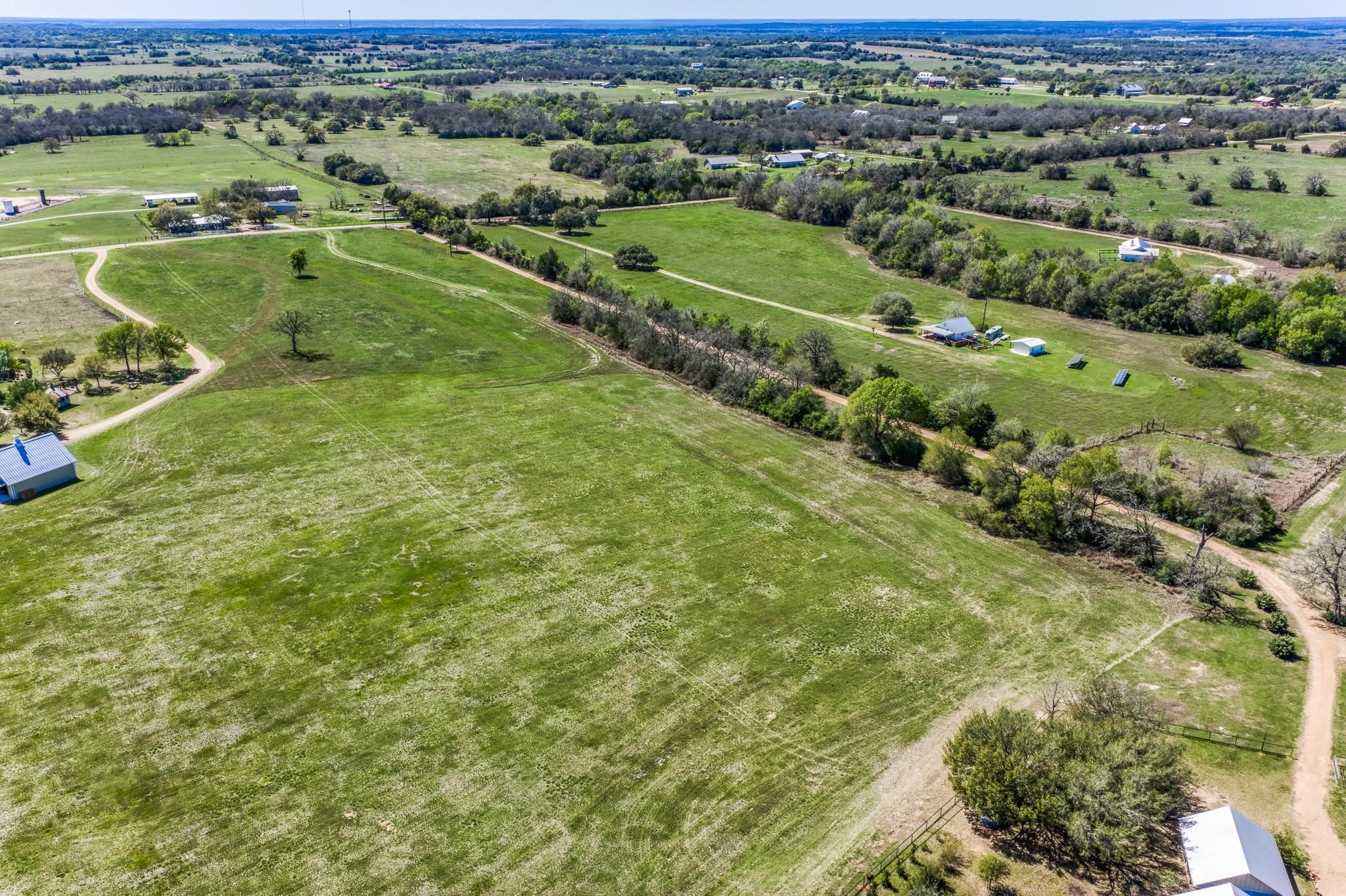11646 Schuster Road Round Top, TX 78954 - Photo 1 of 8 an aerial view of a houses with a outdoor space