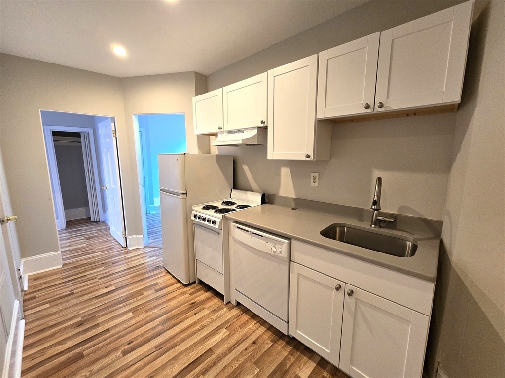 115 Salem Street, Unit 16 Boston, MA 02113 - Photo 2 of 9 a kitchen with a sink cabinets and wooden floor