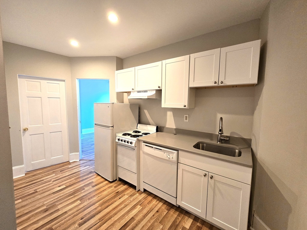 115 Salem Street, Unit 16 Boston, MA 02113 - Photo 3 of 9 a kitchen with stainless steel appliances granite countertop a stove a sink and a refrigerator