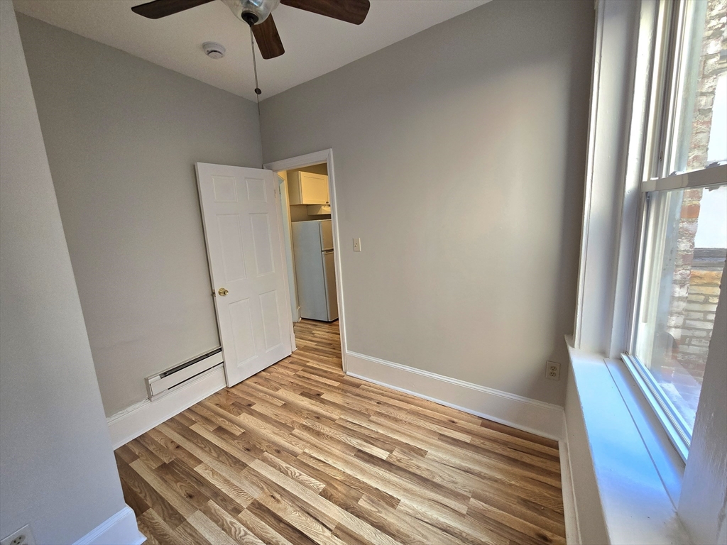 115 Salem Street, Unit 16 Boston, MA 02113 - Photo 5 of 9 a view of a room with wooden floor and a ceiling fan