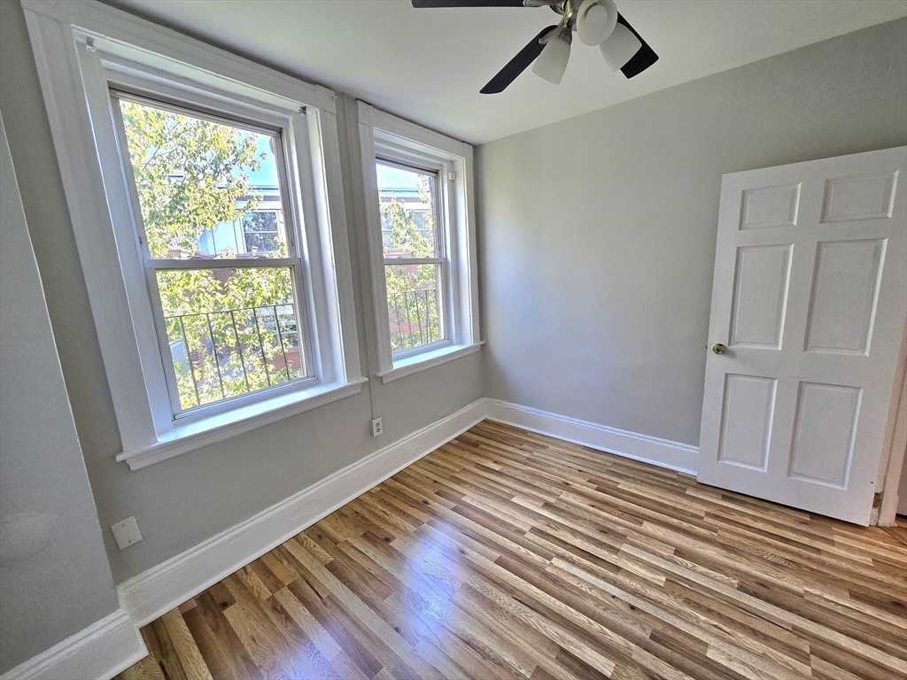 115 Salem Street, Unit 16 Boston, MA 02113 - Photo 8 of 9 a view of an empty room with wooden floor and a window