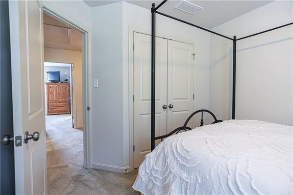 a bedroom with a bed and a mirror