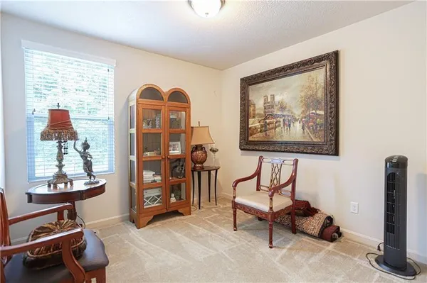 a view of a livingroom with furniture and a window