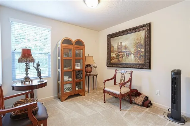 a view of a livingroom with furniture and a window