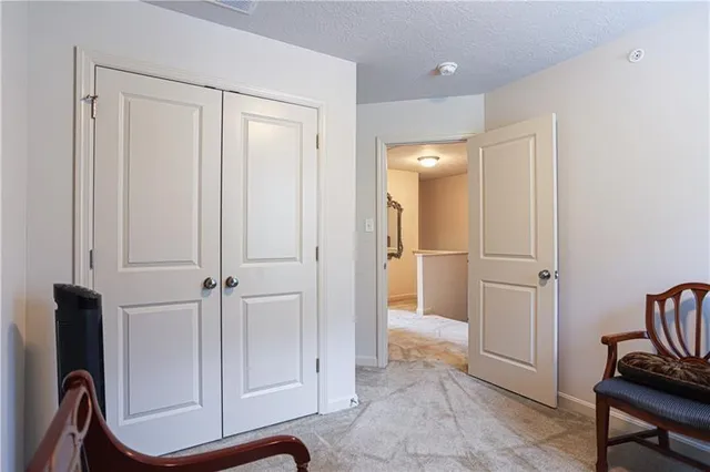 a view of a hallway with closet and wooden floor