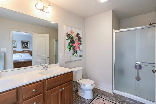 a bathroom with a toilet a sink a vanity and mirror