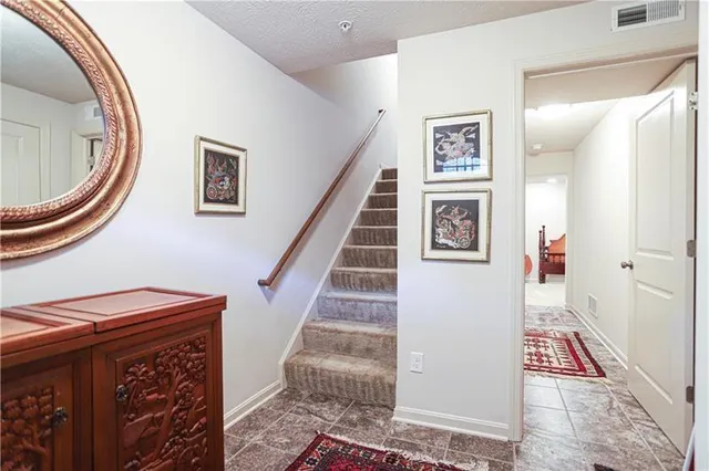 a view of a hallway with entryway wooden floor and front door