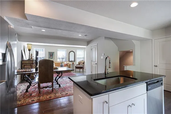 a kitchen with a refrigerator a table and chairs