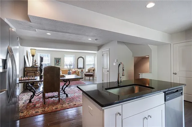 a kitchen with a refrigerator a table and chairs