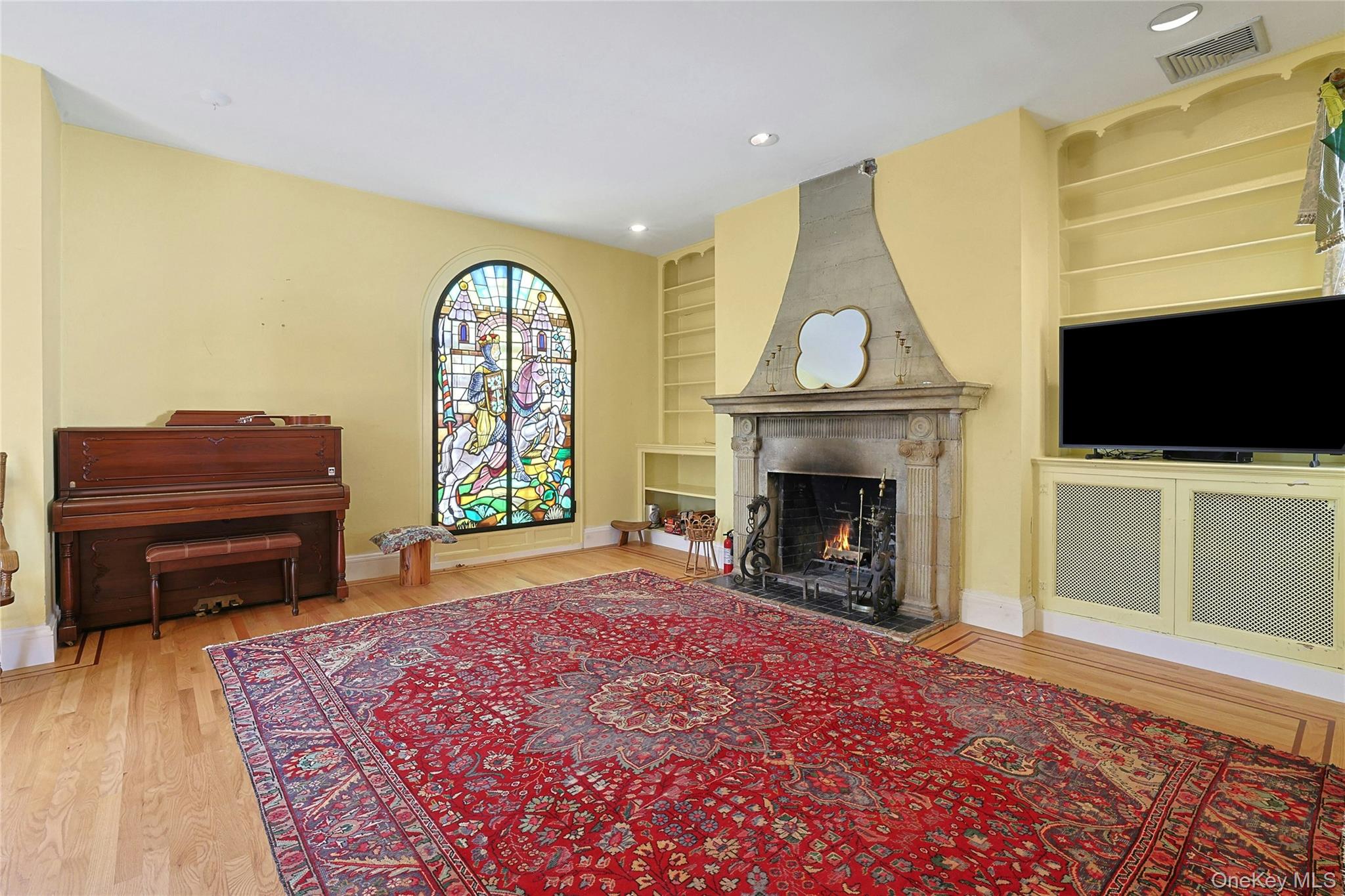 16 Lewis Road Irvington, NY 10533 - Photo 13 of 50 a living room with furniture a fireplace and a flat screen tv