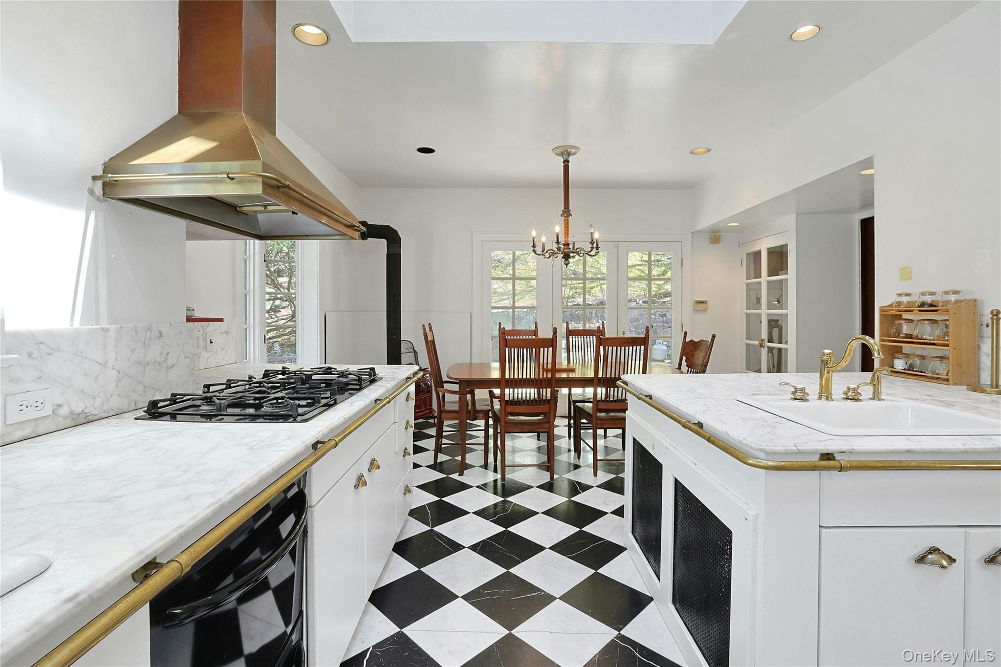 16 Lewis Road Irvington, NY 10533 - Photo 17 of 50 a kitchen with a sink a stove and chairs