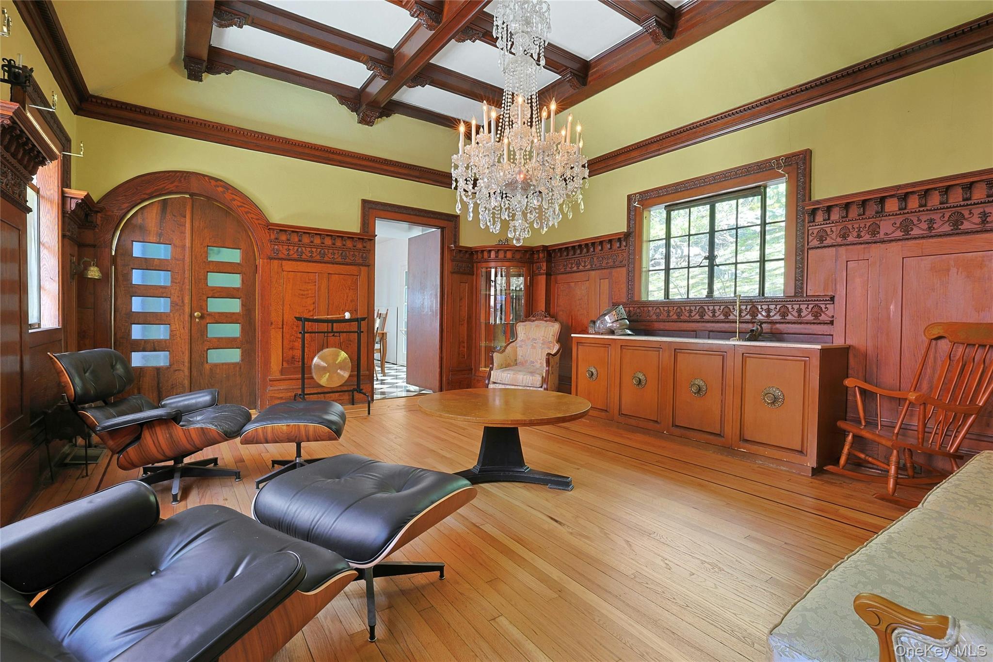 16 Lewis Road Irvington, NY 10533 - Photo 22 of 50 a living room with furniture a chandelier and a wooden floor