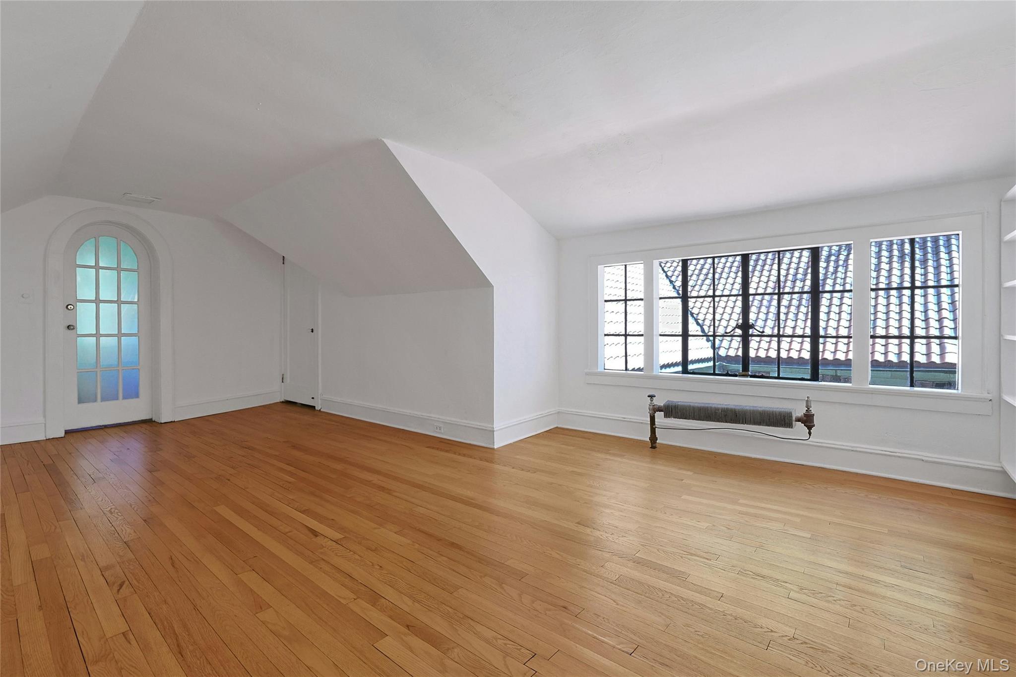 16 Lewis Road Irvington, NY 10533 - Photo 35 of 50 an empty room with wooden floor and windows