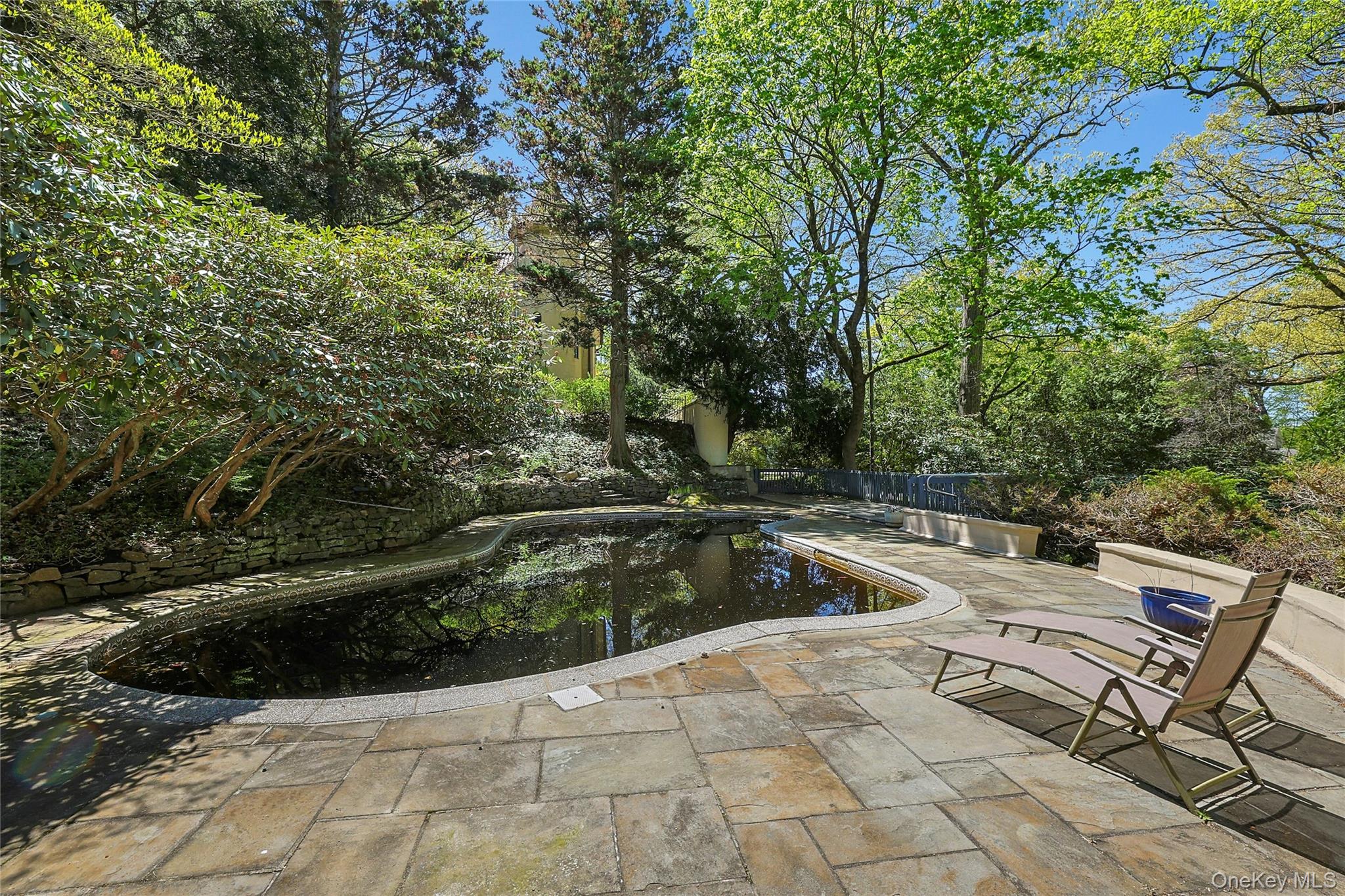 16 Lewis Road Irvington, NY 10533 - Photo 44 of 50 a view of a swimming pool with a lounge chair