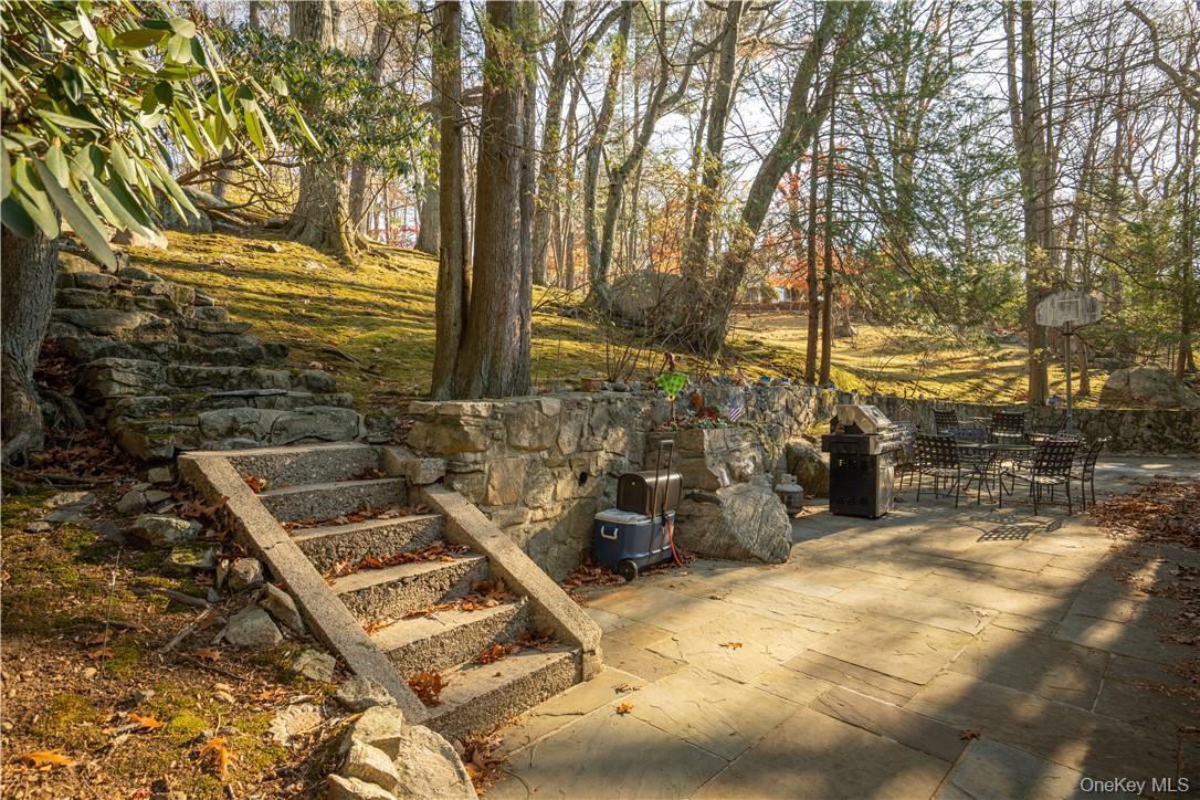 16 Lewis Road Irvington, NY 10533 - Photo 46 of 50 a backyard of a house with table and chairs