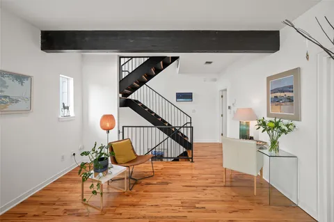 a living room with furniture and a potted plant