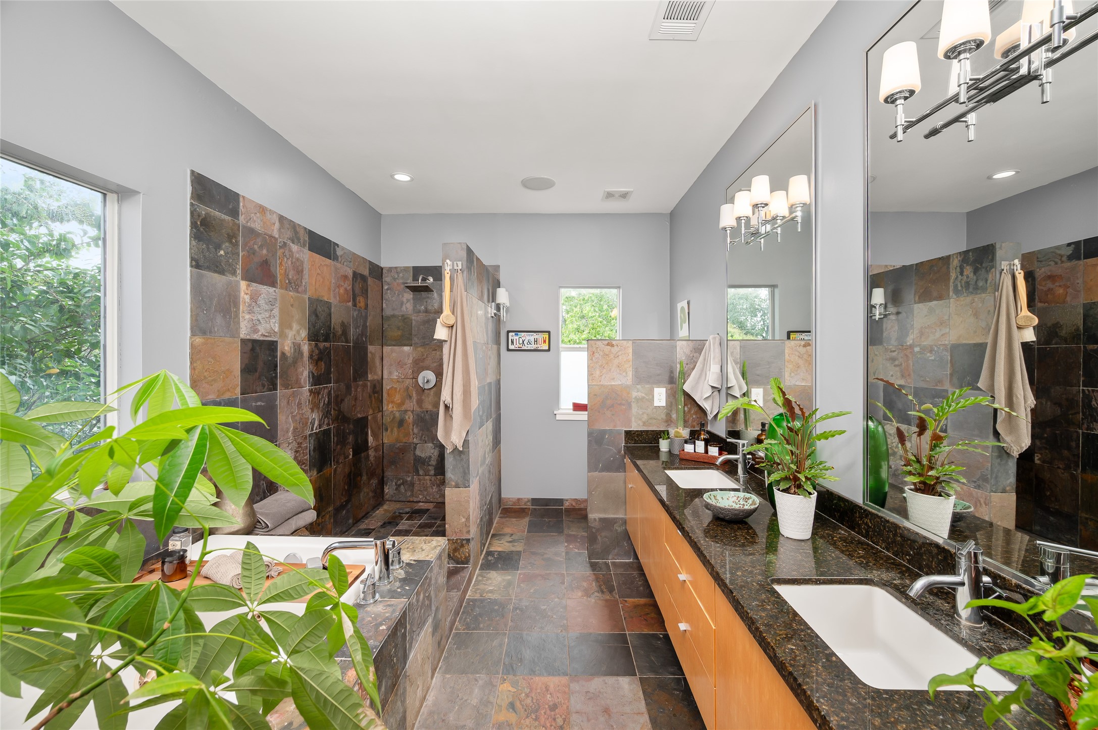 2303 Whitney Street, Unit A Houston, TX 77006 - Photo 22 of 34 Dual vanities, a jetted tub, and a spacious walk-in shower are just a few of the features that transform this primary bath into a true spa-like retreat.