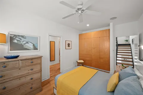 a bedroom with a bed dresser and a window