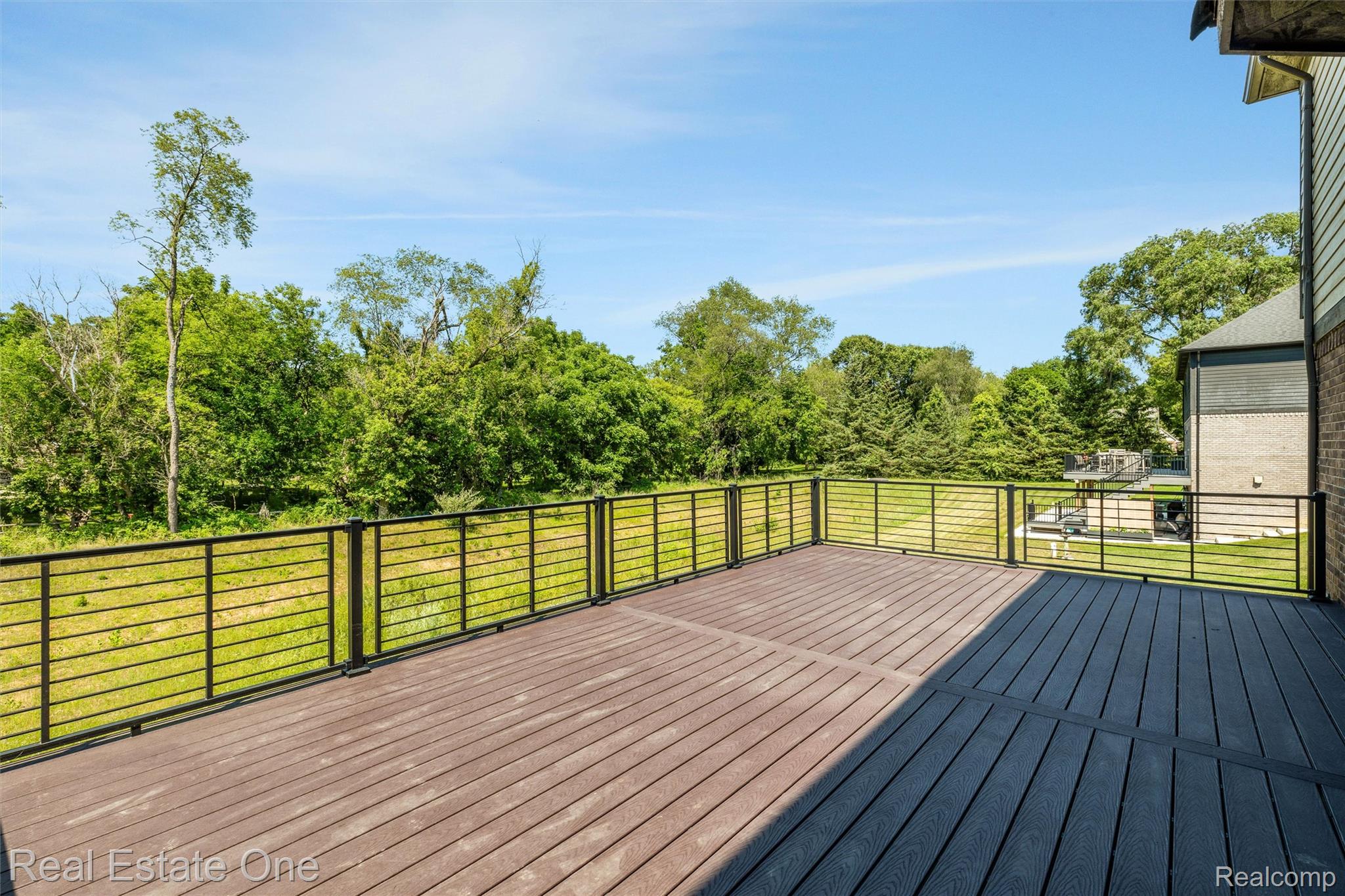 2983 28 Mile Road Washington, MI 48094 - Photo 49 of 54 Spacious outdoor deck featuring multi-toned composite decking and horizontal metal railings