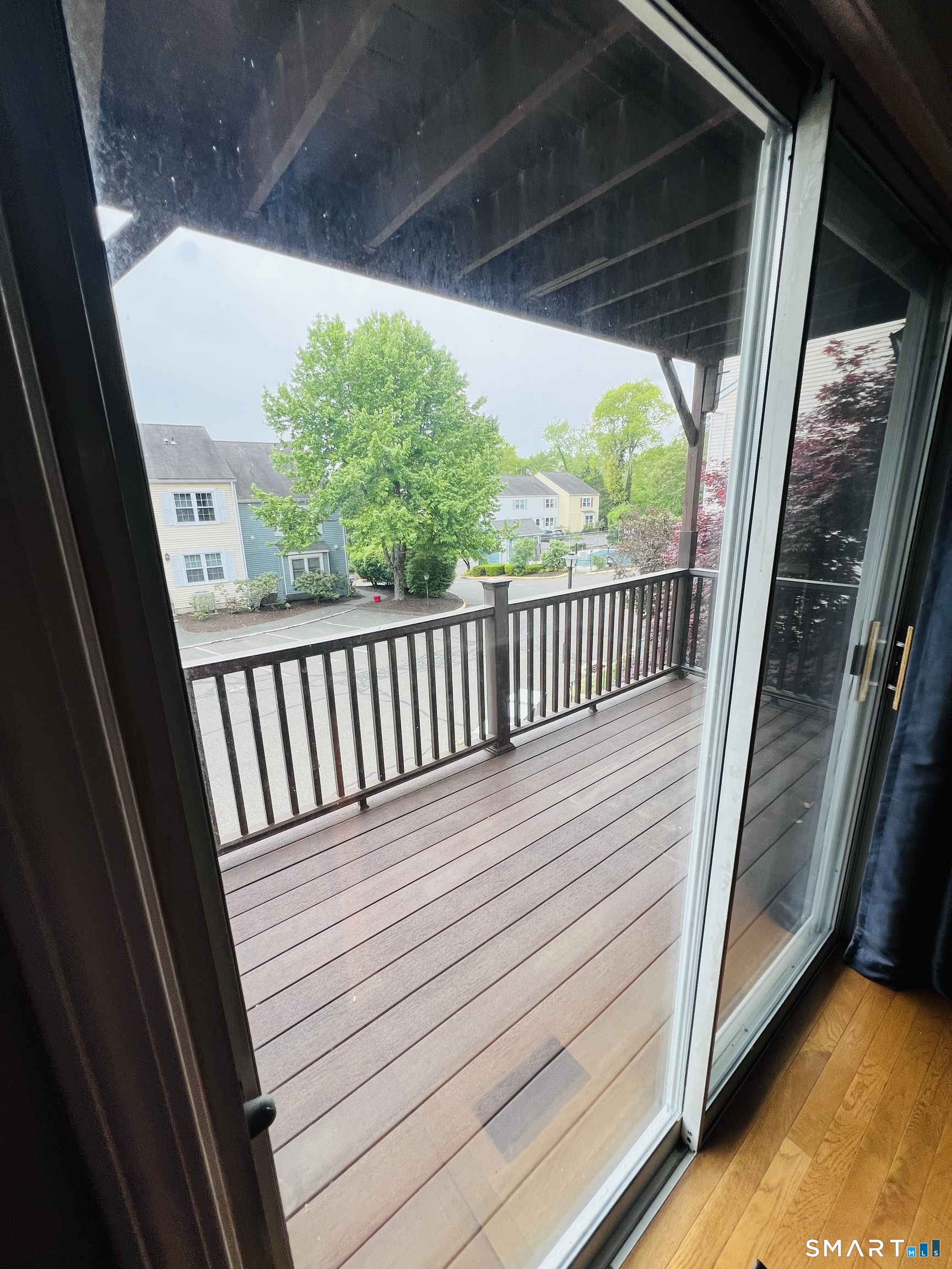 55 Mill Plain Road, Unit 297 Danbury, CT 06811 - Photo 4 of 8 a view of a balcony with wooden floor
