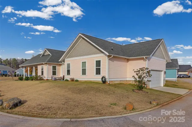 an aerial view of a house with a yard