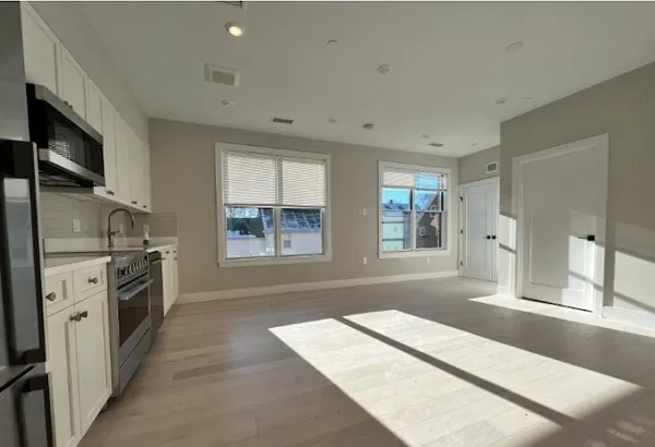 a kitchen with stainless steel appliances granite countertop a stove and a refrigerator