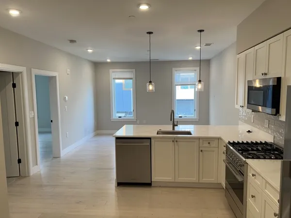 a kitchen with stainless steel appliances a sink stove and refrigerator