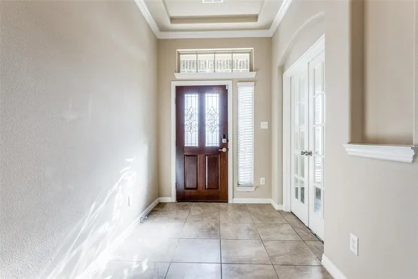 a view of a hallway with wooden shelves and windows