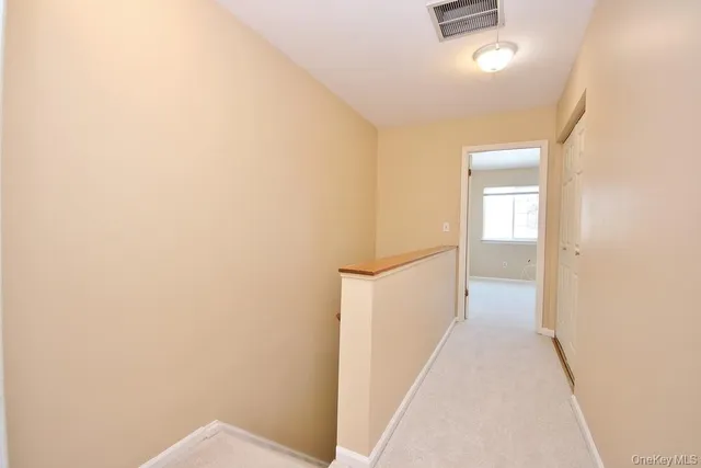 a view of a hallway with a white walls