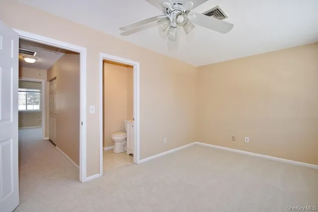wooden floor in an empty room and a bathroom