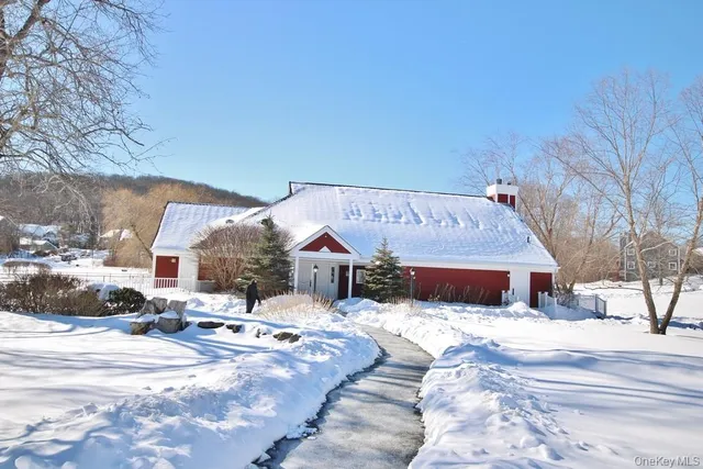 a view of a house with a snow in the yard