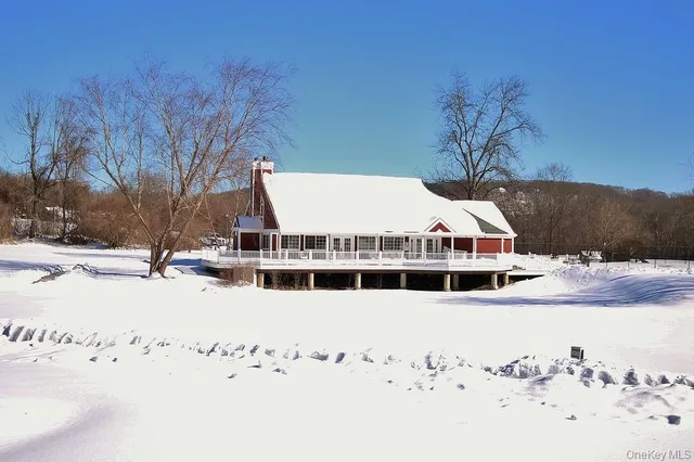 a view of white house with a snow in the background