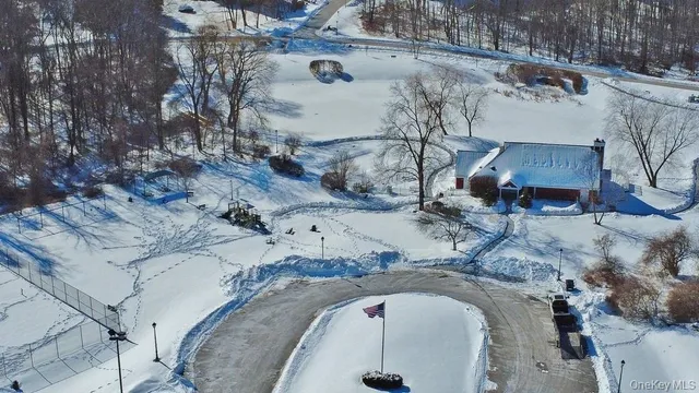 an aerial view of a house with a yard