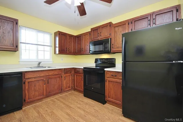 a kitchen with stainless steel appliances granite countertop a refrigerator a stove top oven a sink and dishwasher