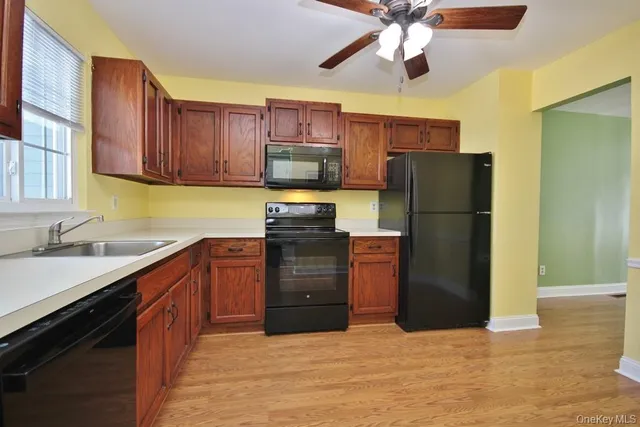 a kitchen with stainless steel appliances granite countertop a refrigerator oven a sink dishwasher and a refrigerator