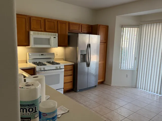 a kitchen with a refrigerator sink and stove