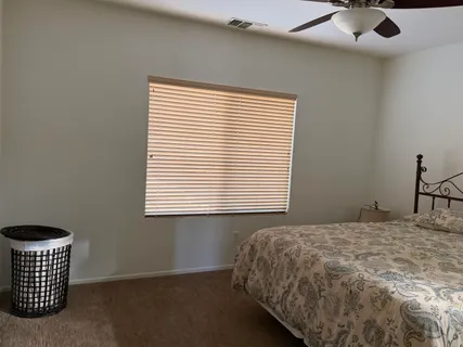 a bedroom with a bed and window