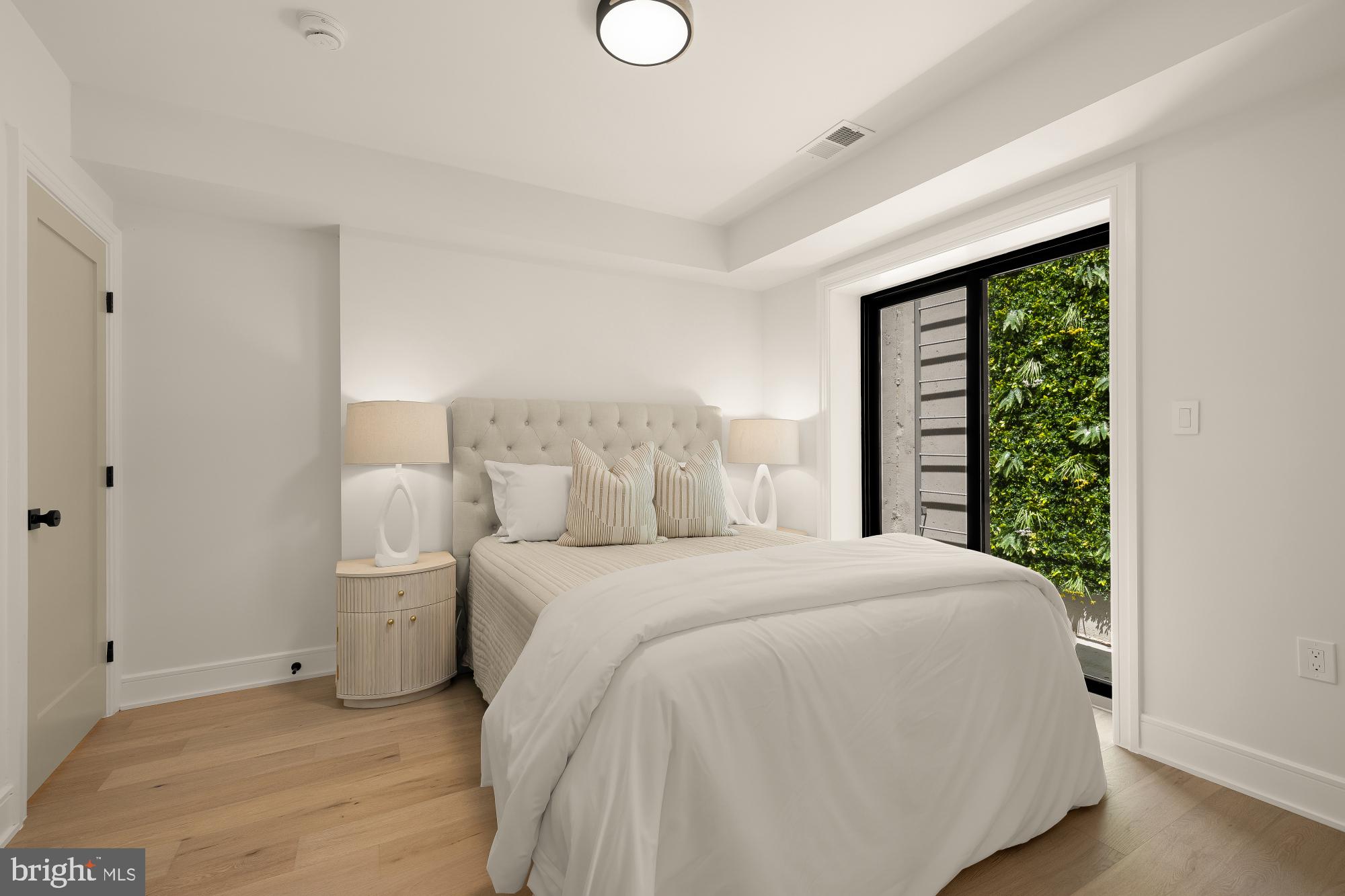 1463 Harvard Street Northwest, Unit 2 Washington, DC 20009 - Photo 20 of 25 a spacious bedroom with a bed and a window